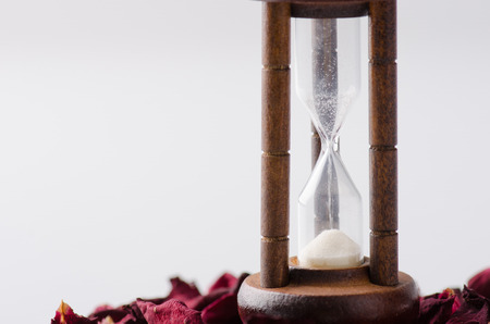 Dried rose petal with sandglass. Time is runing out.