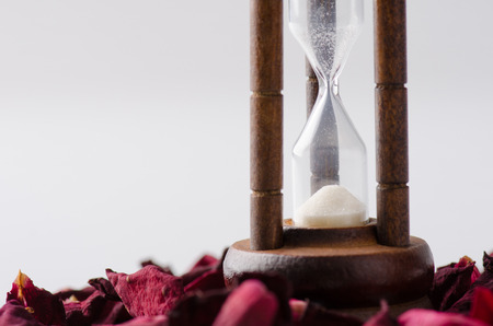 Dried rose petal with sandglass. Time is runing out.