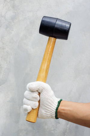 Man holding a rubber hammer.