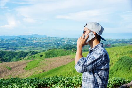Man using a smartphone at the mountain.