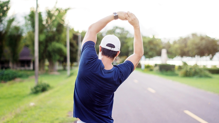 Asian man prepares for a workout at the public park, vintage colors.の写真素材