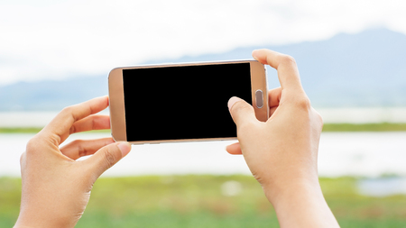Girl taking a landscape photo, soft focus.の写真素材