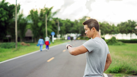 Asian man prepares for a workout at the public park, soft focus.の写真素材