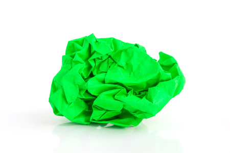 Crumpled green paper ball on a white background.の写真素材