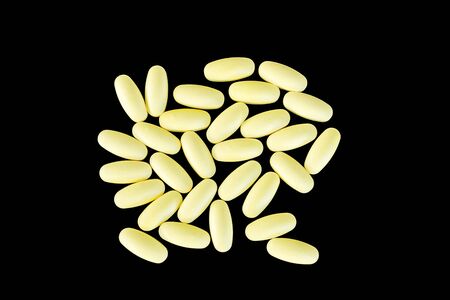 Yellow bunch of drugs on a black background.の写真素材