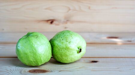 guava fruit on a wooden background, soft focus.の写真素材