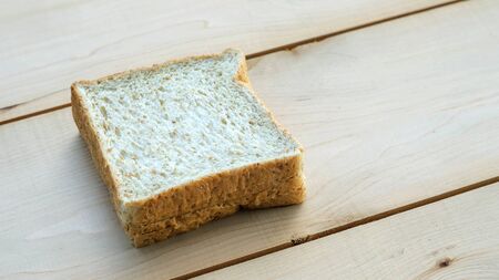 whole wheat bread on wooden background.