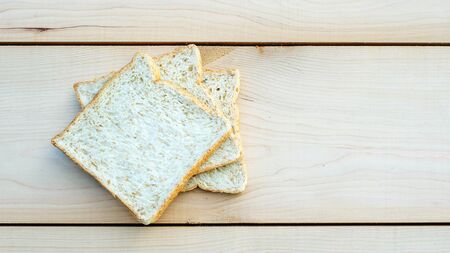 whole wheat bread on wooden background.