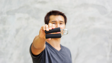 Man use handgrips for exercise.の写真素材