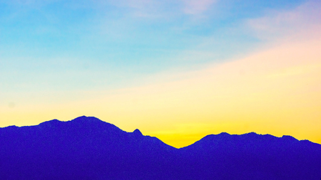 silhouette mountain ranges on the sunset background.の写真素材