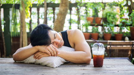 Young Asian man sleeping in a garden.の写真素材