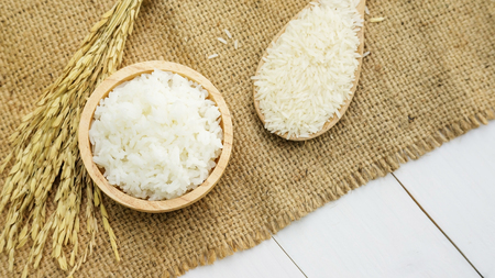 Jasmine rice in a bowl on a wooden table.の写真素材