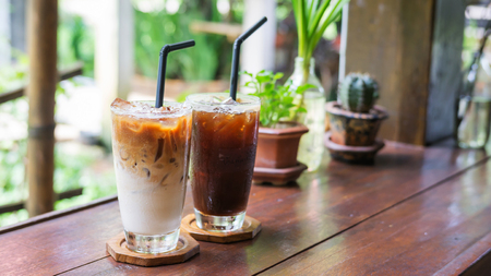 iced latte and americano coffee on a wooden table.の写真素材