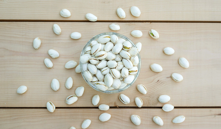 Pistachios on a wooden table.