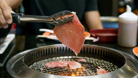 meat grilling on a charcoal grill.の写真素材