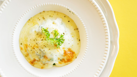 Baked Spinach with Cheese on a white plate.