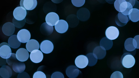 blue bokeh on a dark background.