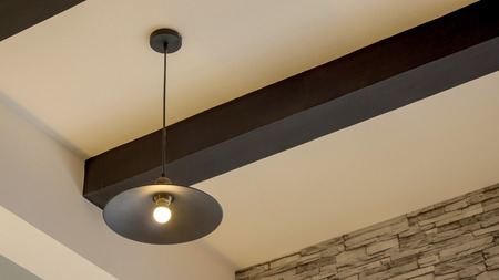 A lamp hanging on a ceiling.