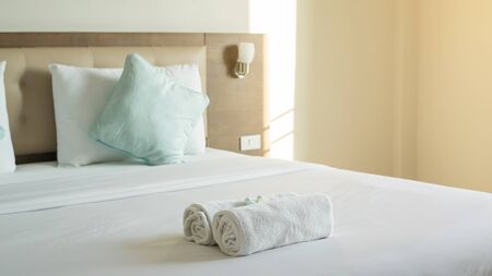 White towel shampoo and soap on a bed.の写真素材