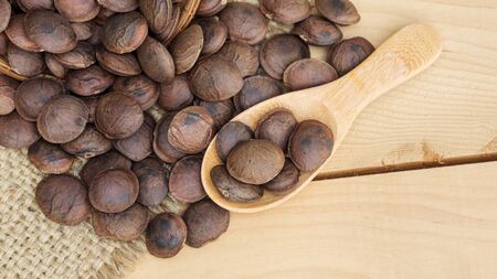 Sacha Inchi seeds in a spoon on a wooden table.の写真素材