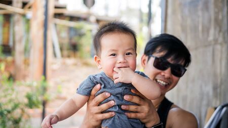 Asian cute child was carried by a man.の写真素材