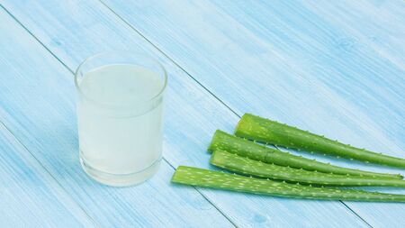 Aloe vera juice on a blue wooden table.の写真素材