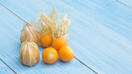 Cape gooseberry on a blue wooden table.の写真素材