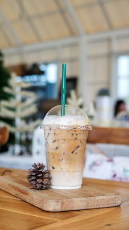 Iced latte coffee on a wooden table in a cafe.の写真素材