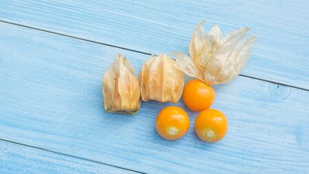 Cape gooseberry on a blue wooden table.の写真素材