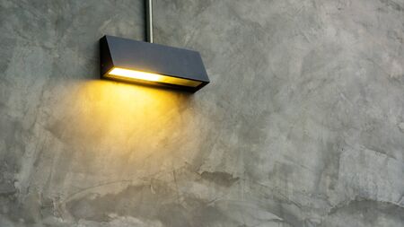 Black lamp shine on a gray wall.の写真素材