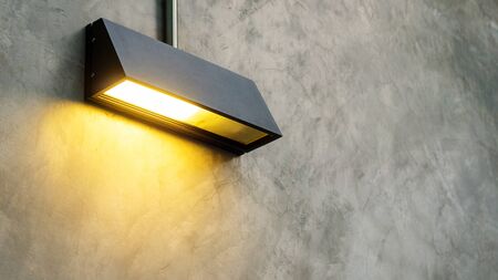 Black lamp shine on a gray wall.の写真素材
