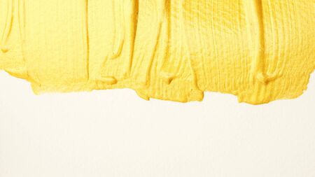 Gold colored poster watercolor on white background.の写真素材