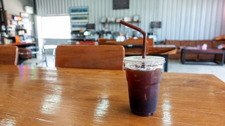 Iced americano on a wooden table in a cafe.の写真素材