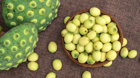 Green lotus seeds on a wooden table.の写真素材