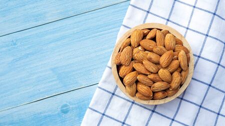 Almond on a blue wooden table.の写真素材
