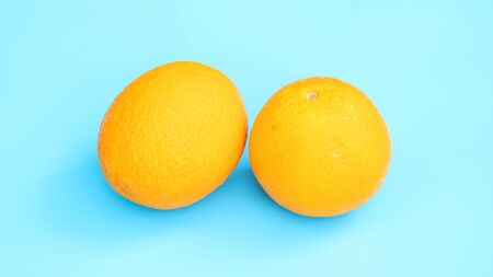 Oranges fruit on a blue background.の写真素材