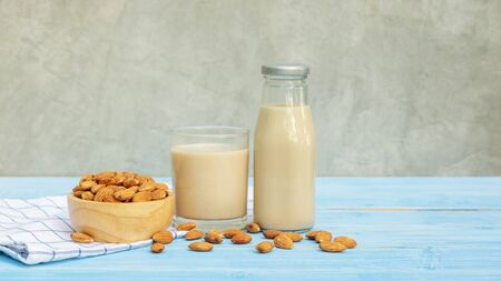 Almond milk on a blue wooden table.の写真素材