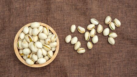 Pistachio nuts on a brown sack.の写真素材