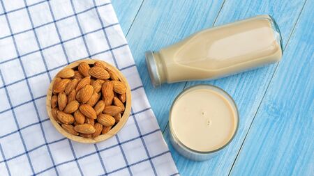 Almond milk on a blue wooden table.の写真素材