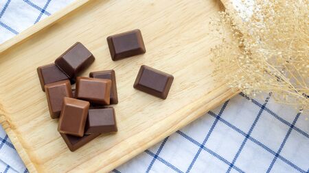 Chocolate on a wooden plate.の写真素材