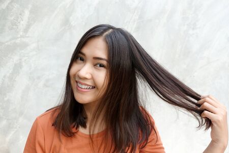 Asian women touch her hair on grayの写真素材