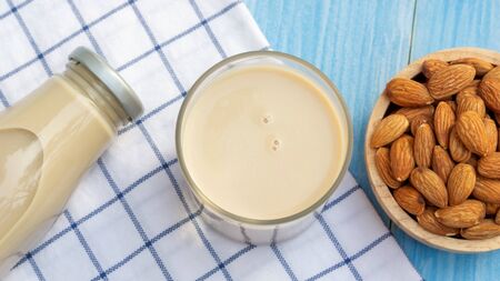 Almond milk on a blue wooden table.の写真素材
