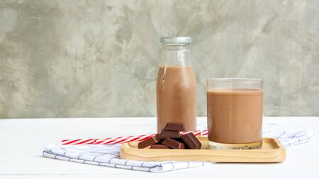 Chocolate milk on a white wooden table.の写真素材