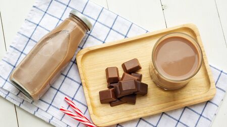 Chocolate milk on a white wooden table.の写真素材