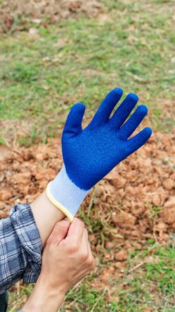 Men wearing a blue glove prepare for agriculture.の写真素材