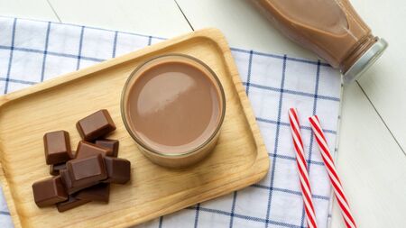 Chocolate milk on a white wooden table.の写真素材