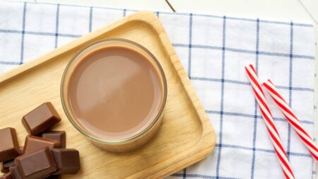 Chocolate milk on a white wooden table.の写真素材