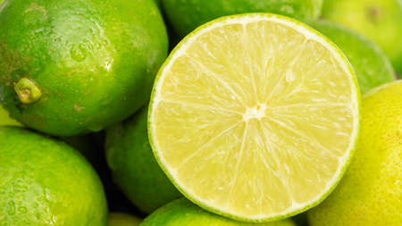 Close up of a half of green lime in a basket.の写真素材