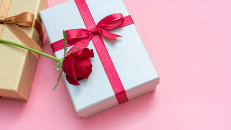 Red rose and gift box on a pink background.の写真素材