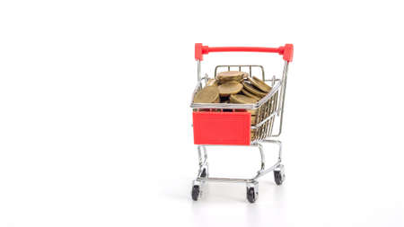 Golden coin in a shopping cart on a white background.の写真素材